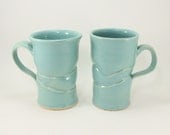 handmade pair of green mugs