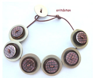 Button bracelet jewelry made of vintage shell buttons and new shell buttons beaded on leather cord