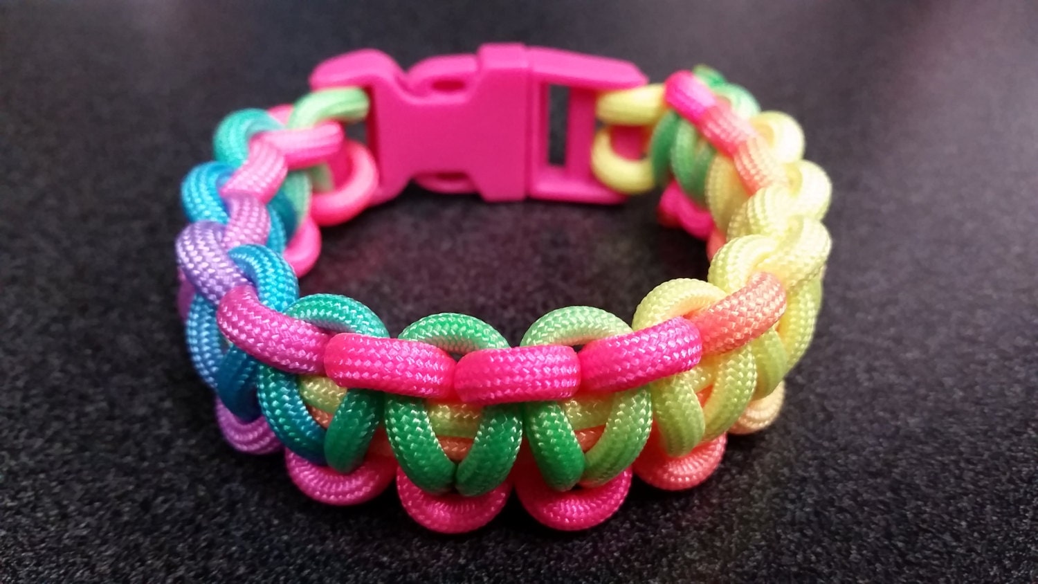 Rainbow tie dye paracord bracelet with pink buckle