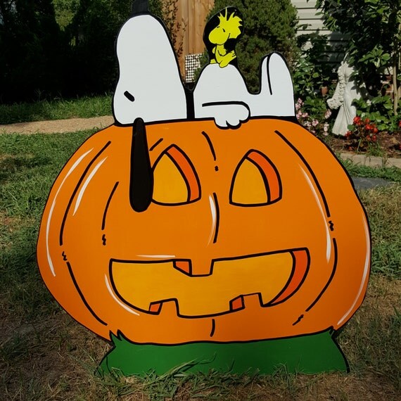 Snoopy laying on a pumpkin Taking a nap on the jack o