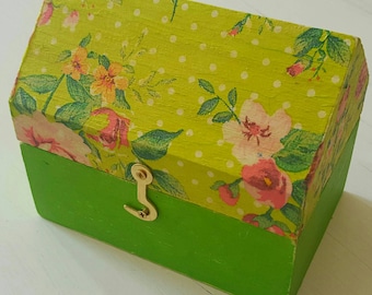 A shabby chic and decopage jewellery box in a house shape. Very colourful