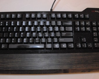 Keyboard wrist rest made out of wood.