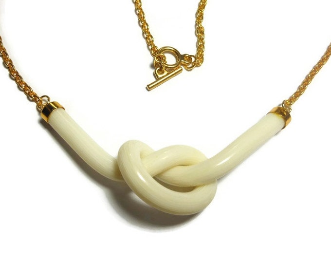 Cream knot necklace, creamy white striated knot focal plays center stage with a gold plated link chain and toggle clasp