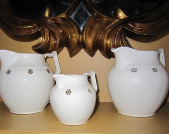 Vintage Hall China Pitchers and Creamer with gold starburst pattern