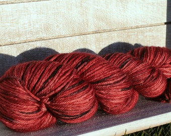 Hand dyed worsted weight yarn in red and black Arizona Cardinal coloryway, Indie yarn in a worsted weight wool, Merino superwash wool dyed