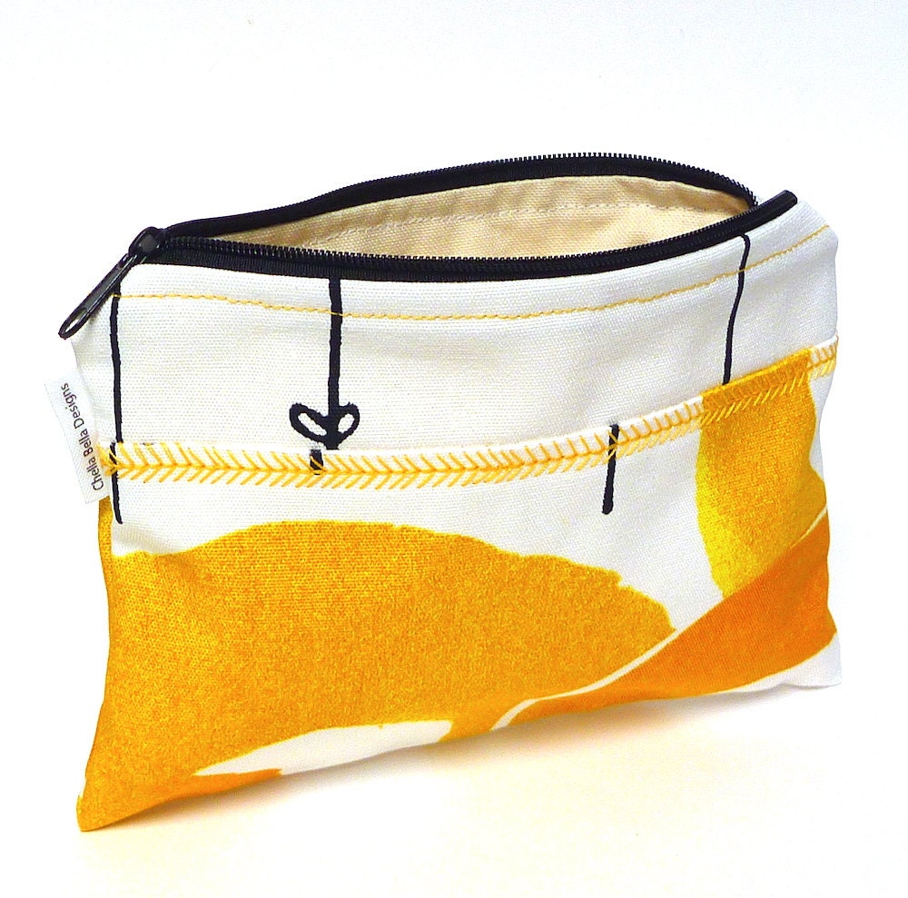 Yellow and white cosmetic bag with decorative stitching