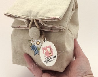 Mini linen cosmetic sack featuring machine embroidery design