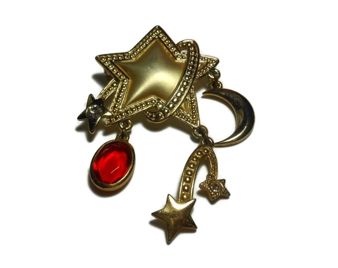 Falling stars brooch, large star with charms of shooting stars, moon and glass marquise cut red oval, rhinestones embellish falling stars