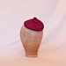 Handmade raspberry red cord fascinator decorated with a handmade ribbon rose
