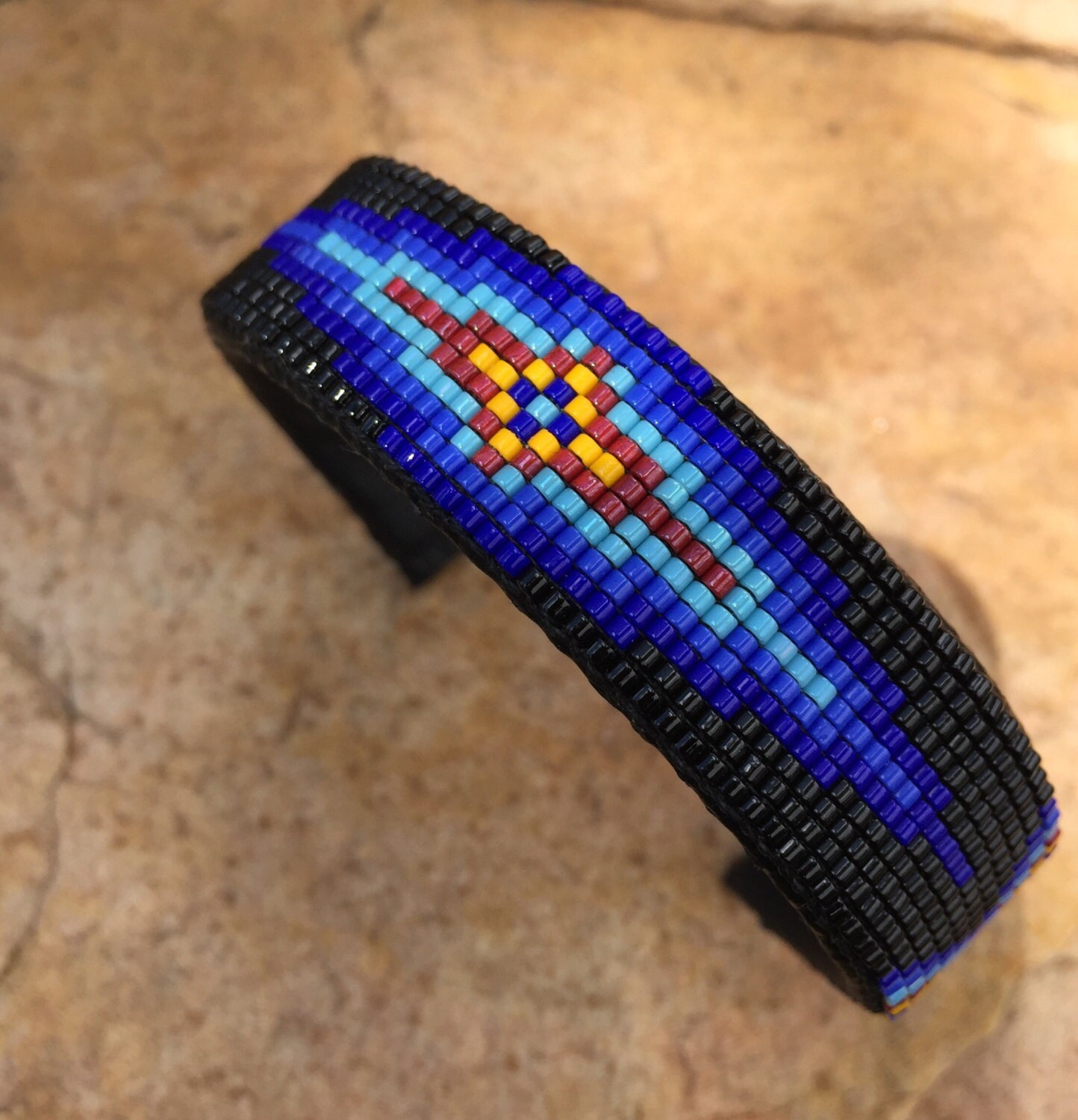 Beaded Geometric Design Bracelet in Blues and Red on a Black