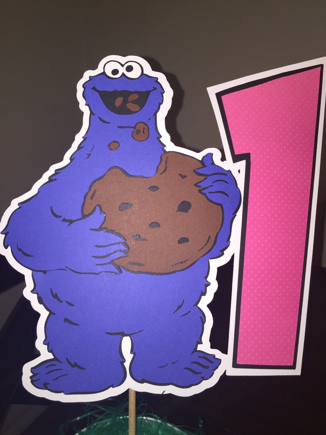 sesame streets cookie monster with the number 1 sign for