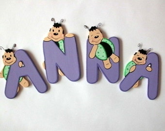 Wooden alphabet letters with a small beetle