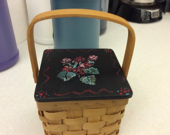 Wicker Basket has Wood hinged lid with Geraniums painted on top