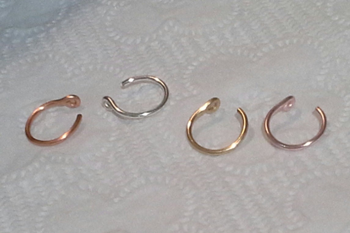 Any TWO. 18 gauge Nose rings. Sizes 8.5mm 1cm.