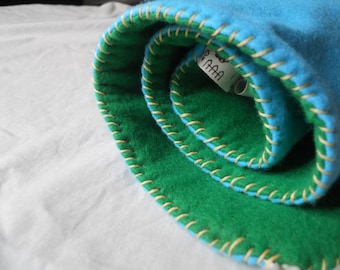 Portable blue and green double-sided felt board learning mat. Folds and fits into your purse and can be used anywhere.