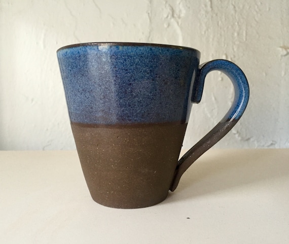 Ceramic modern black clay coffee mug in blue.