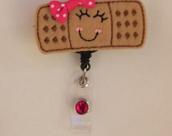 Cute Bandaid Badge Reel with Polka Dot Bow and Gemstone!