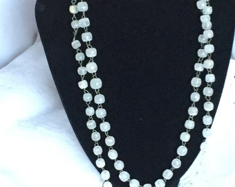 Handcrafted long necklace of clear sea glass beads and silver wire chain