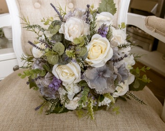 Rustic ivory and lavender wedding bridal bouquet. Made with artificial roses, hydrangea, heather, lavender and simple greenery.