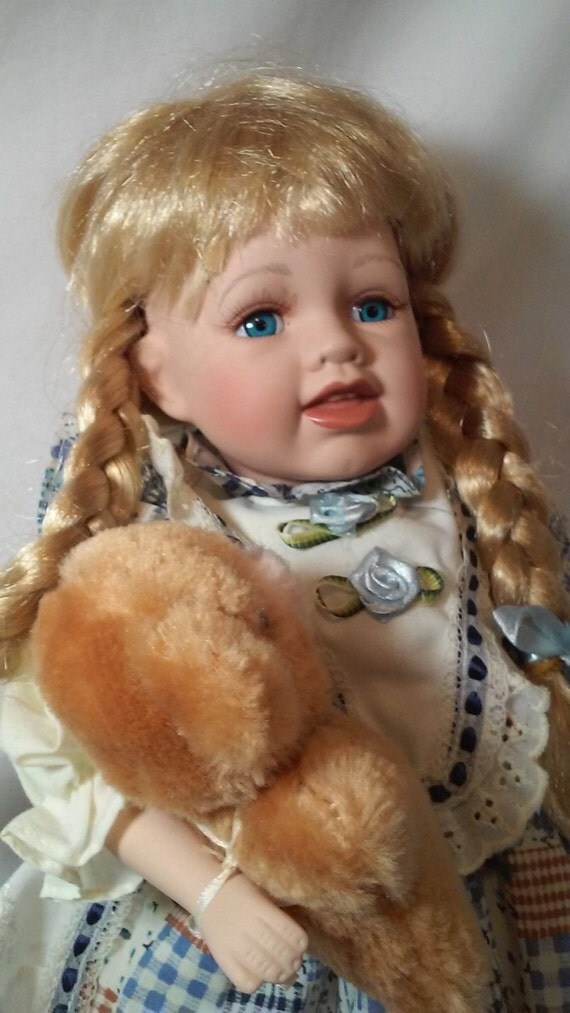 porcelain doll with teddy bear