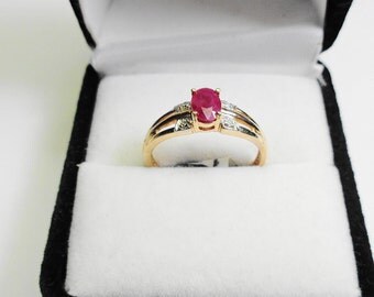 6 x 4 mm. Natural Ruby in a 10kt. Gold Ring with Diamond Accents.