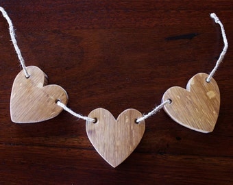 Triple heart horizontal crafted from a french oak aged wine barrel.