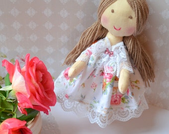 The rag doll Mary doll in handmade dress doll brown hair doll games and of the interior little doll for a gift.