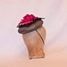 Stunning gunmetal coloured occasion hat with fuchsia pink rose decoration