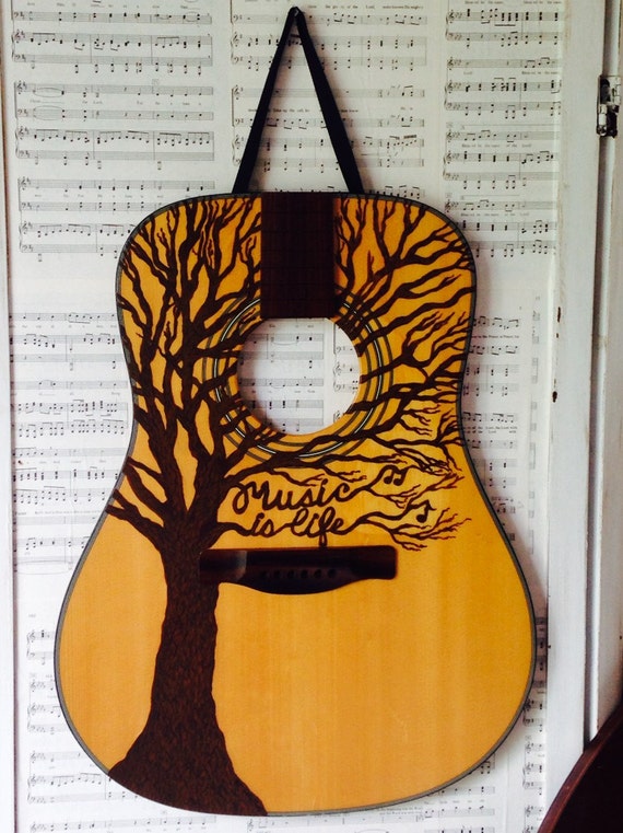Repurposed guitar wall hanging "Music is Life" painting on a adult sized acoustic guitar front