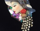 Vintage brooch -Lovely Sophisticated woman draped in a scarf of rhinestones with delicate features wearing a wide brim hat. Vintage brooch -Lovely Sophisticated woman draped in a scarf of rhinestones with delicate features wearing a wide brim hat.