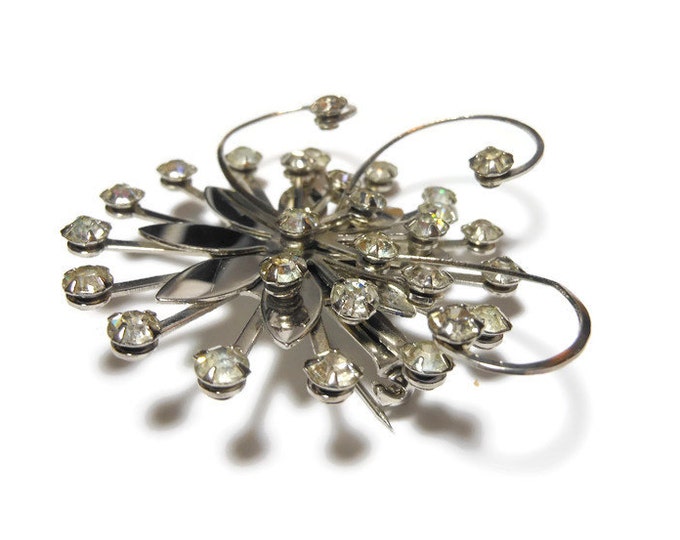 Rhinestone daisy brooch, clear rhinestones, silver tone flower, swirl pinwheel design, 1930s estimated age, faceted prong set