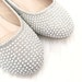 white flats with pearls