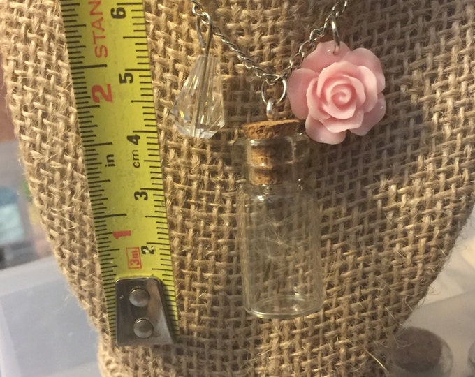 Wish in a bottle with a pink flower