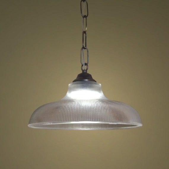 Large glass pendant lighting on a brass chain. Hanging large