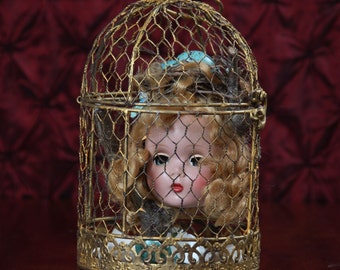 Songbird. Mixed-media, assemblage, vintage doll head, bricolage
