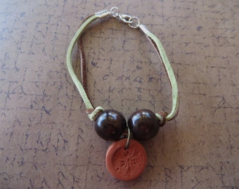Green and Brown Leather Bracelet with Brown Wood Beads and Stamped Terra Cotta Charm