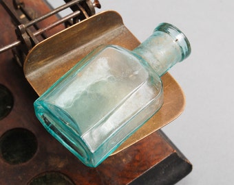 Antique small blue glass bottle, medical or laboratory bottle.