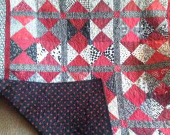 Black, white and red lap quilt