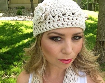 Crocheted cream colored beanie hat with a flower by Antseas