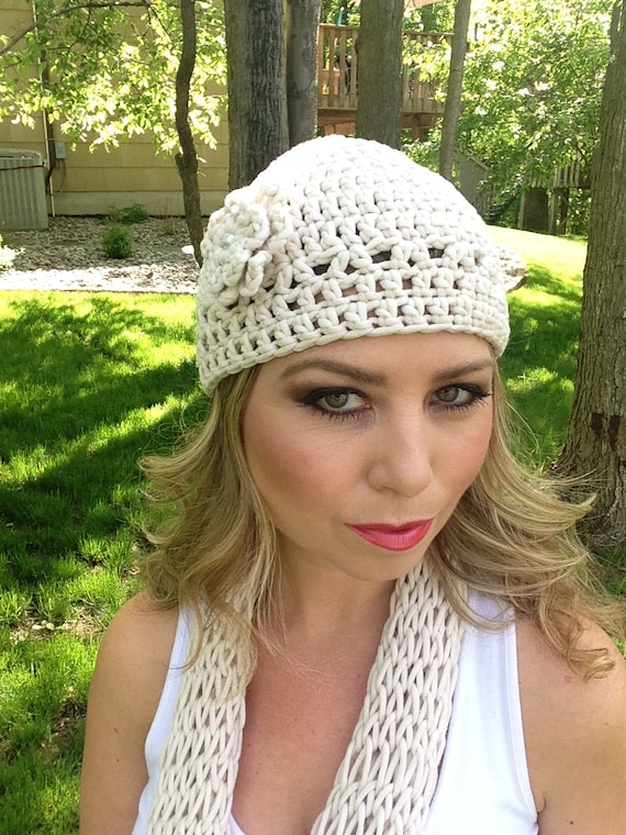 Crocheted cream colored beanie hat with a flower by Antseas