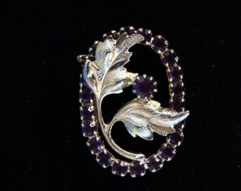 Gold flower brooch with purple rhinestones