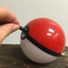 Hand-made Pokeball Themed Battery Pack / Phone Charger / Power bank (attaches to belt loop or backpack with a keychain clasp)