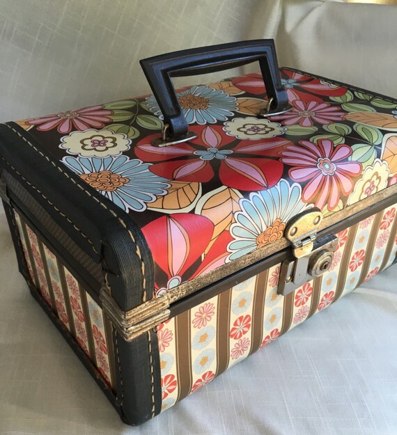 Up Cycled vintage train case. A mixture of floral, stripes and dots create a uniqe look. Unique storage for a variety of items.
