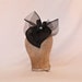 Handmade black heart shaped hat decorated with diamanté details
