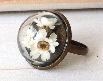 Ring with glass dome and flowers