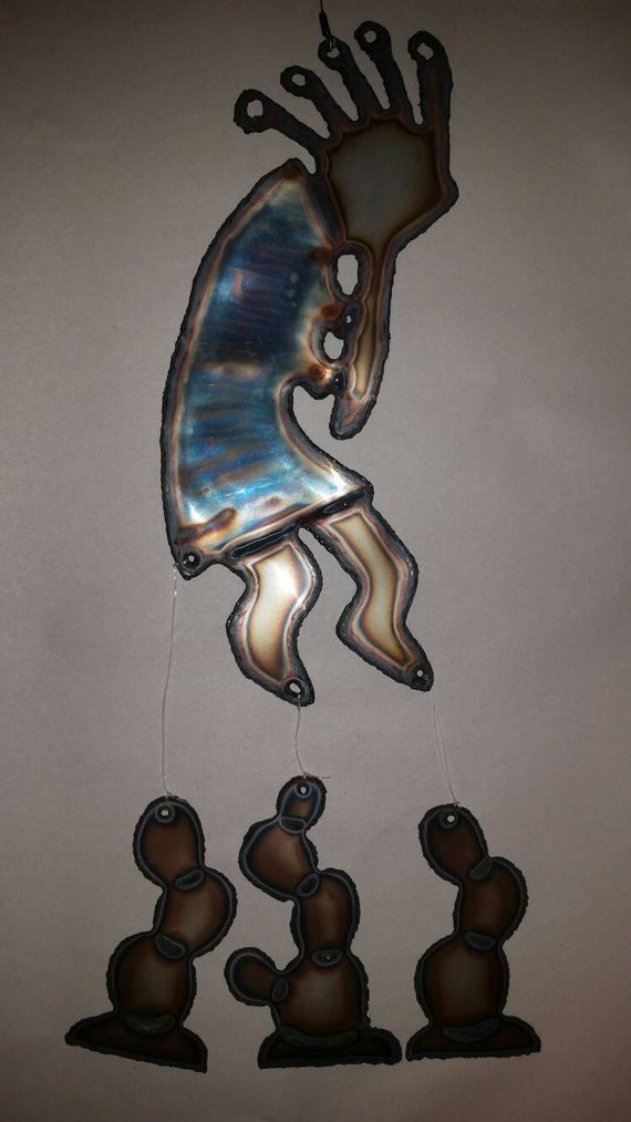Kokopelli wind chime with cactus hanging.