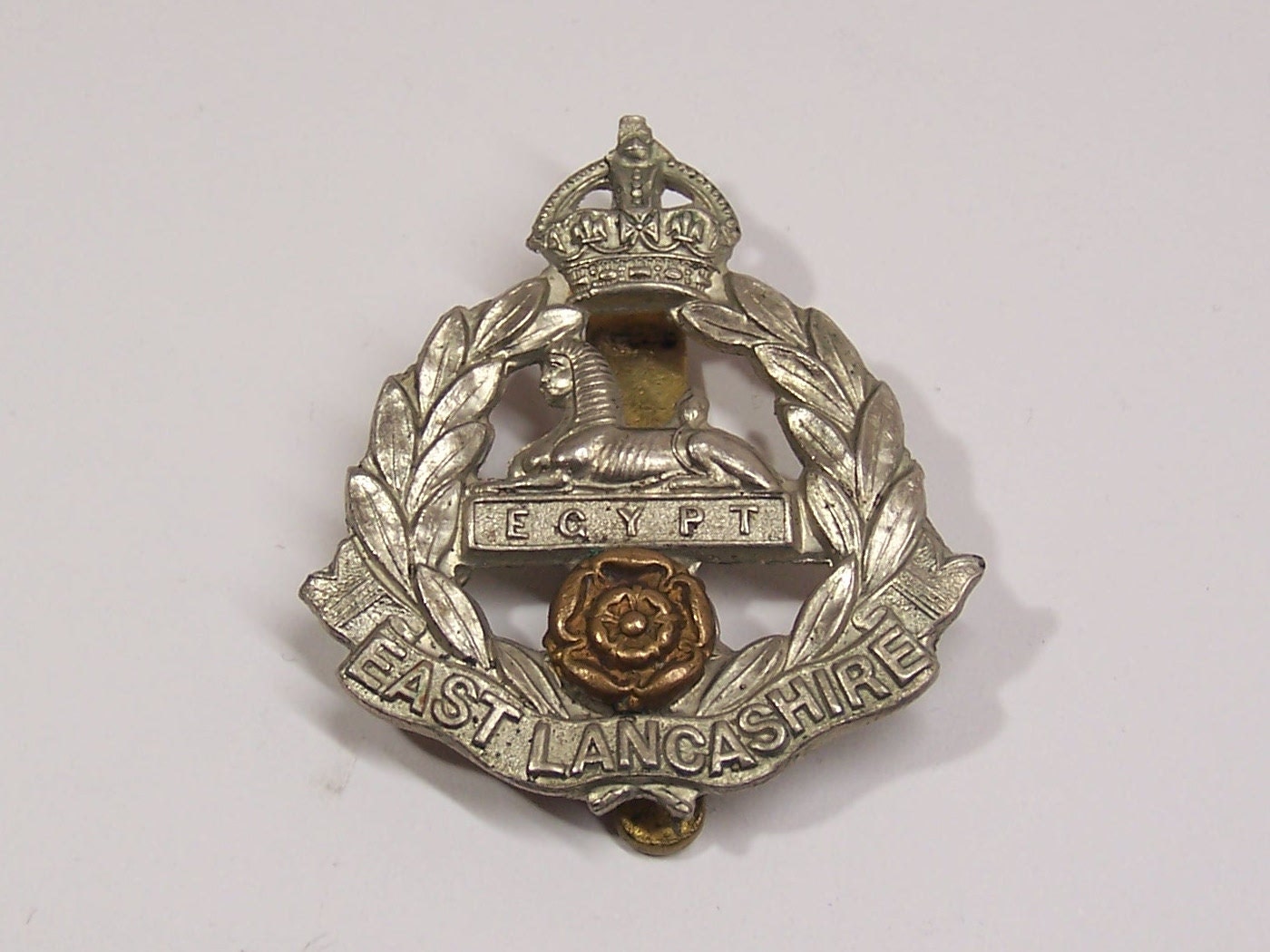 antique British military East Lancashire Regiment cap badge