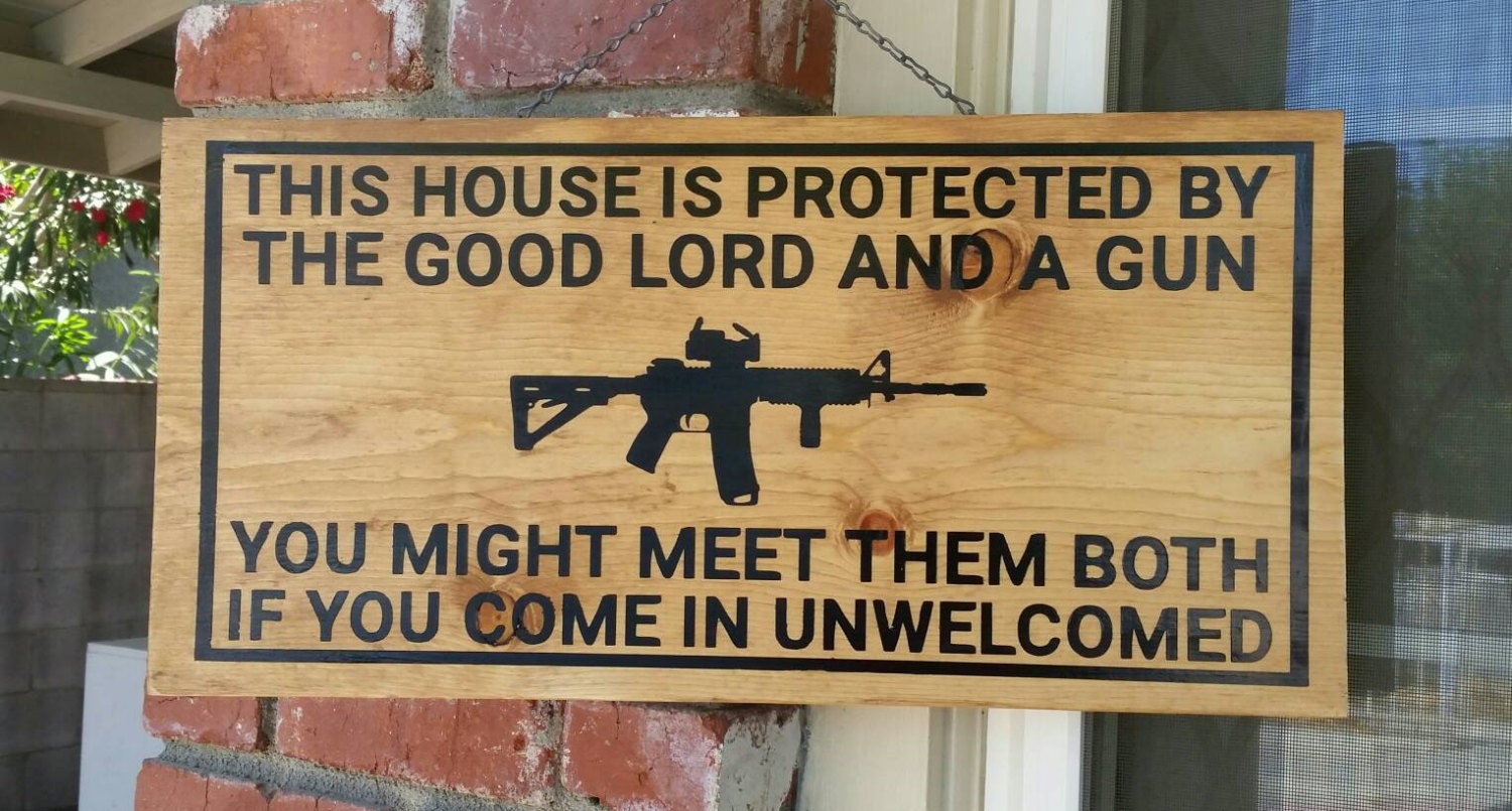 This house is protected by the good lord and a gun sign