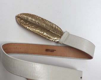 Large gold feather belt buckle on soft leather belt