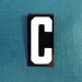 vintage 40's letter C industrial metal sign 1.5" long .5" wide black & white hanging small little tiny mini baked on enamel church board old